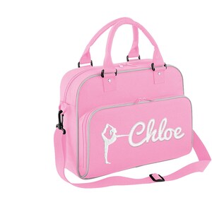 May include: Pink dance bag with a white silhouette of a dancer and the name "Chloe" embroidered on the front.