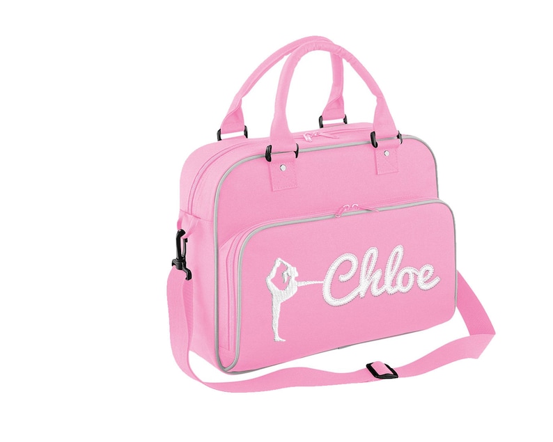 May include: Pink dance bag with a white silhouette of a dancer and the name "Chloe" embroidered on the front.