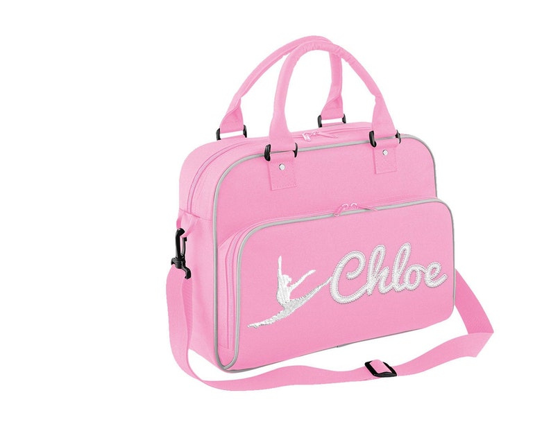 May include: Pink dance bag with a silver glitter ballerina silhouette and the name "Chloe" in silver glitter lettering.