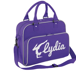 May include: Purple gym bag with a white embroidered gymnast silhouette and the name "Lydia".