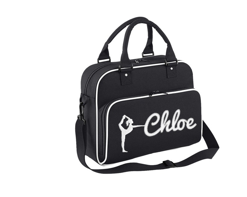 May include: Black gym bag with a white trim and a white embroidered gymnast silhouette and the name "Chloe".