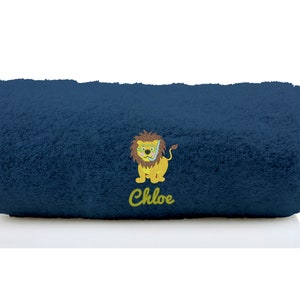 K&ouml;nnte beinhalten: Ein dunkelblaues Handtuch mit einem gelben L&ouml;wen, der eine Taucherbrille tr&auml;gt, und dem Namen "Chloe" bestickt.