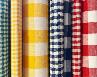 May include: Five fabric swatches with a gingham pattern in different colors: green, yellow, blue, red, and white.