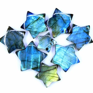 May include: A collection of eight blue and green labradorite star-shaped crystal points.