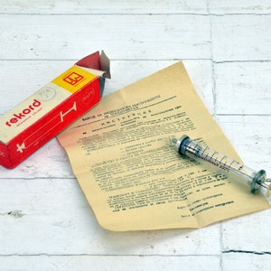 Vintage Glass Medical Syringe: Unused Doctor Tool with Instructions