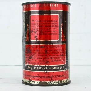 May include: A vintage metal can of coffee with red and black text. The can reads "Кофе, натуральный высшего сорта - смесь нескольких видов кофе подобранных для создания лучшего, вкуса - и аромата напитка." and "СРОК ХРАНЕНИЯ 5 МЕСЯЦЕВ".