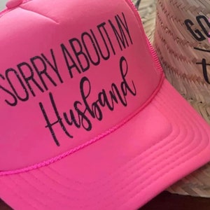 Hot pink, trucker hat, sorry about my husband.