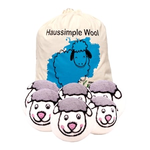 May include: A cream-colored bag with the text "Haussimple Wool" and a blue sheep graphic. Below the bag are six white wool dryer balls with gray wool "hair" and sheep face designs with pink noses and smiling mouths.