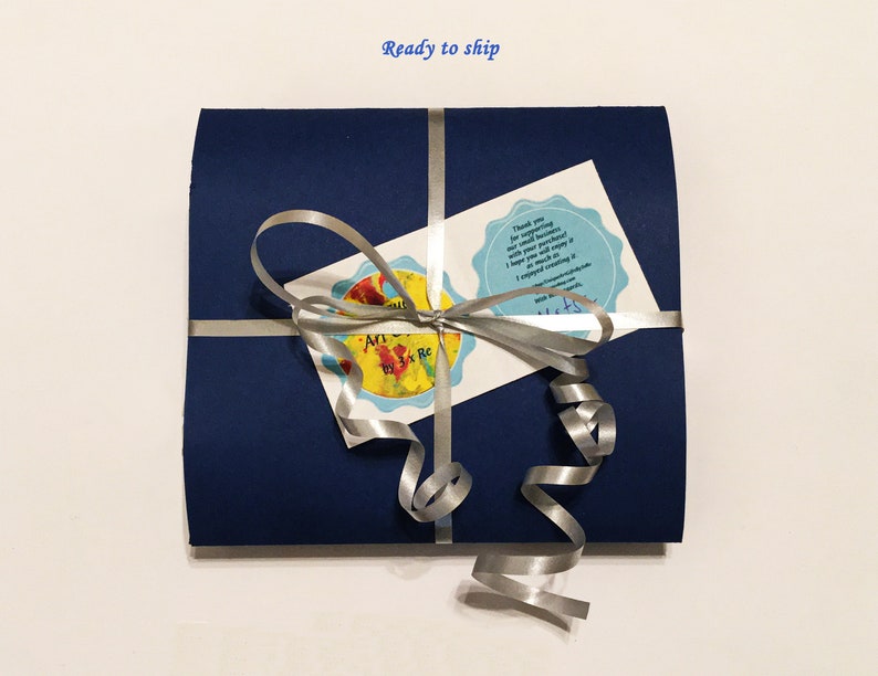 Navy blue gift sleeve wrapped with a silver ribbon and bow, including thank you message, which shows the packaging is ready to ship.