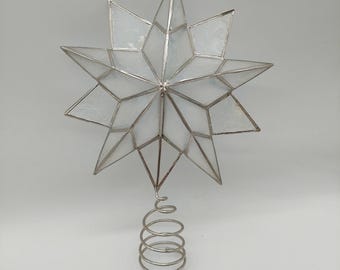 Adorno para árbol de Navidad en forma de estrella de concha de capiz, translúcido con ribete plateado.