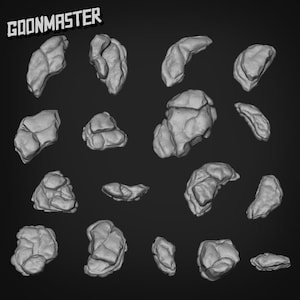 May include: A collection of 16 grey, rock-like shapes, resembling small, irregular boulders. The shapes are arranged in a random pattern against a dark grey background. The word "GOONMASTER" is printed in white at the top of the image.