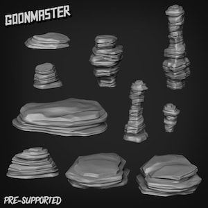 Può includere: Un set di 9 formazioni rocciose stampate in 3D pre-supportate per giochi da tavolo o scenografie in miniatura. Le rocce sono di varie forme e dimensioni, alcune sono alte e sottili, mentre altre sono piatte e larghe. Le rocce sono tutte grigie e hanno una superficie ruvida e testurizzata.