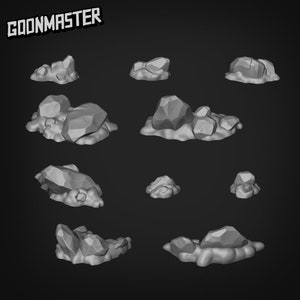 May include: A selection of grey, stylised rock formations, each with a textured, polygonal surface. The rocks vary in size and shape, some clustered together, others isolated. The word "GOONMASTER" is printed in a bold, angled font at the top.
