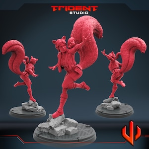 May include: A red painted miniature figurine of a female superhero with a bushy tail, wearing a red and black costume, standing on a gray base. The figurine is posed in a dynamic action pose with one leg raised.