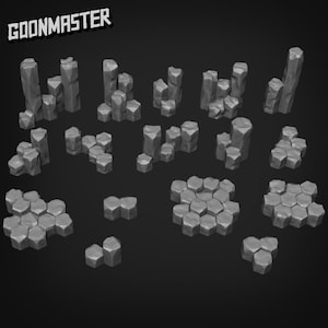 Pode incluir: Uma coleção de formações rochosas geométricas cinzentas, de vários tamanhos e formas, dispostas sobre um fundo escuro. O texto "GOONMASTER" é visível no canto superior esquerdo. Estas peças de terreno impressas em 3D são adequadas para jogos de mesa.