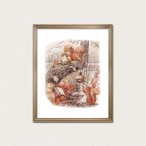 May include: A framed print featuring a watercolor illustration of several squirrels in a natural setting. The squirrels, depicted in shades of brown and orange, are interacting near a tree and water, creating a whimsical scene.