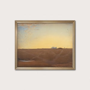 May include: A framed landscape painting featuring a golden sunset over a rolling brown field. The artwork depicts a distant stone structure and a flock of birds in the sky. The frame is gold.