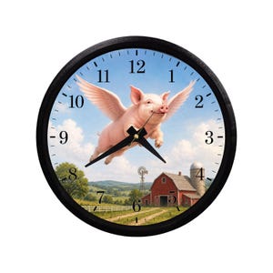 May include: A round wall clock with a black frame and a white face featuring black Arabic numerals. The center image depicts a pink pig with feathered wings flying over a rural landscape with a red barn, a silo, and a windmill under a blue sky.