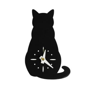May include: A black cat-shaped wall clock with white clock hands and a gold-colored center. The clock has a minimalist design with small, white dot hour markers. The cat is sitting with its tail curled.