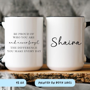 May include: White ceramic mug with black trim and handle. One side features the text "BE PROUD OF WHO YOU ARE and never forget THE DIFFERENCE YOU MAKE EVERY DAY." The other side has the name "Shaira" in cursive. The mug holds 15 oz and is printed on both sides.