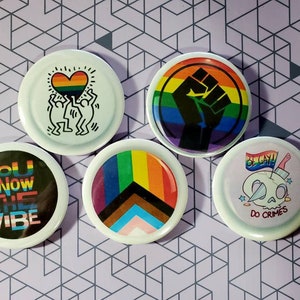 Gay Pride 2.25 Inch Button Badges Set of 5. Great quality waterproof buttons. Includes a free bonus button!!