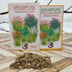 May include: Two seed packets for a short and sweet seed collection. The packets are yellow and white with a colorful illustration of flowers and grasses. The text on the packets reads "Short & Sweet Seed Collection" and includes the size of the packet, either 0.5 oz or 0.25 oz. The packets are on a wooden surface with a pile of seeds in the foreground.