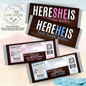 May include: Hershey's chocolate bar wrappers customized for baby announcements. The wrappers feature the text "HEREHEIS" with the baby's name, birth details, and nutrition facts. The wrappers are brown with white and pink or blue text.