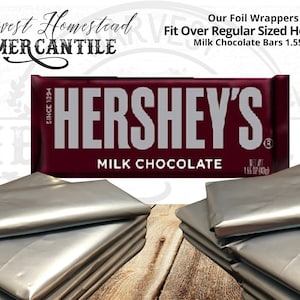 May include: Silver foil wrappers for Hershey's Milk Chocolate bars. The wrappers are designed to fit over regular sized Hershey's bars, which are 1.55 ounces. The image shows a stack of five wrappers.
