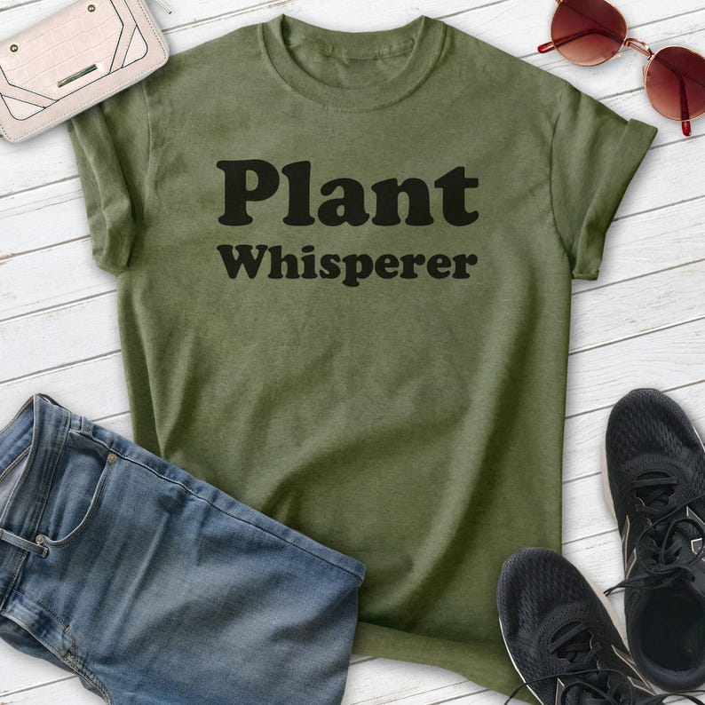 May include: A green t-shirt with the text "Plant Whisperer" in black letters.