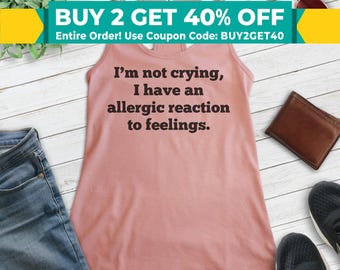 May include: A pink tank top with the text "I'm not crying, I have an allergic reaction to feelings." printed in black.