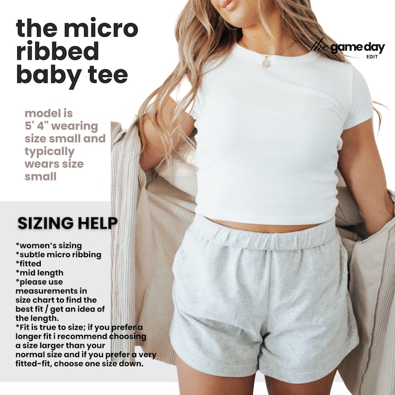 The image is a promotional graphic for a baby t-shirt, featuring a woman wearing a white t-shirt and gray shorts. The text provides information about the size and fit of the t-shirt, suggesting that it is a micro ribbed baby tee.