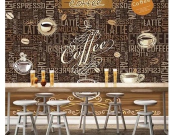 May include: A coffee-themed wall mural with the word "coffee" in a decorative script. The background features coffee-related words and images of coffee cups and beans. A wooden bar with stools is in the foreground.