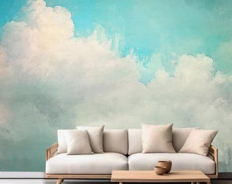 Könnte beinhalten: Ein weißes Sofa mit drei Kissen steht vor einer Wand mit einem bemalten Himmel und Wolken. Der Himmel ist hellblau mit weißen Wolken. Das Sofa ist aus Holz und hat eine helle Holzoptik.