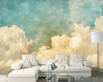 Könnte beinhalten: Ein weißes Ecksofa mit einem Wandbild im Vintage-Stil mit Wolken in Hellblau und Gelb. Das Sofa hat zwei weiße Kissen und einen Tisch mit Büchern und einer Lampe.