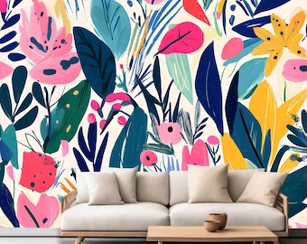 May include: A white couch with three white pillows sits in front of a wall with a colorful floral pattern. The pattern features pink, yellow, blue, and green flowers and leaves.