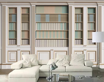 May include: A white sectional sofa with a white floor lamp and three white bookshelves filled with colourful books. The bookshelves have gold trim and are against a white wall.
