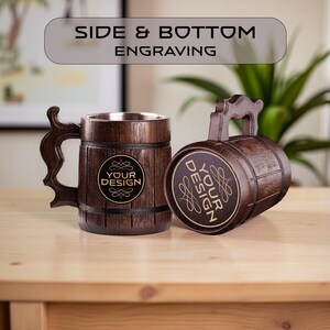 May include: Two wooden beer mugs with a barrel design. One mug is upright, the other is on its side. Both mugs have a handle and a metal interior. The text "YOUR DESIGN" is on the front of each mug. The text "SIDE & BOTTOM ENGRAVING" is at the top.