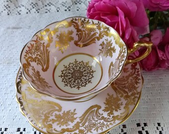 PARAGON English Cup and Saucer. Made in England Signed and numbered. Very good condition Vintage collectible Gold leaf pink cream bone china