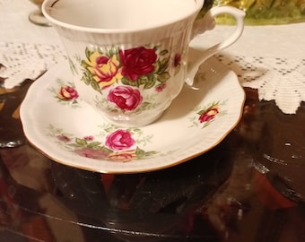 CRYSTAL CLEAR Fine china. Made in Poland. Teacup and saucer set. Gift wrapping available. White with red, pink fushia, and yellow gold roses