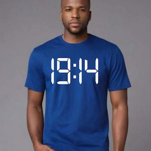 May include: A royal blue t-shirt with a white digital clock graphic displaying the time 19:14.