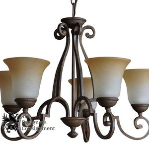 May include: A five-light chandelier with a wrought iron frame and frosted glass shades. The chandelier has a rustic, antique finish.