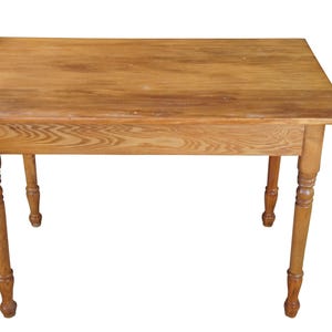 May include: A rectangular wooden table with a light brown finish. The table has four turned legs and a simple design. The table measures approximately 30 inches long, 20 inches wide, and 28 inches high.