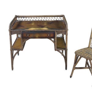 May include: Wicker desk and chair set. The desk has a drawer and two side shelves. The chair has a tall back. The set is made of woven brown wicker.