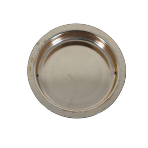 May include: A round, silver-colored metal lid with a slightly raised edge.