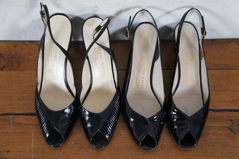 May include: Four black leather peep-toe slingback heels with gold buckles. The heels are all labeled "Bruno Magli" on the inside.
