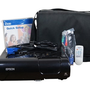 May include: A black Epson EX90 projector with a remote control, a carrying case, and cables. The projector has a quick setup guide.