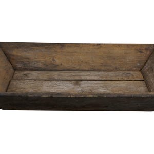 May include: A rustic wooden tray with a rectangular shape and a slightly curved edge. The tray is made of natural wood with a weathered finish.