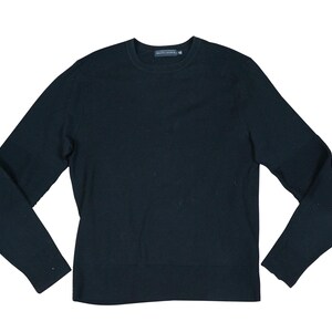 May include: A black long-sleeved sweater with a crew neck.