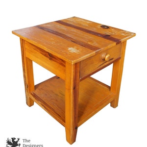 May include: A rustic wooden end table with a single drawer and a lower shelf. The table is made of reclaimed wood and has a natural finish.