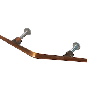 May include: A bronze-colored cabinet pull with a curved handle and two silver screws. The handle has a rectangular shape and is slightly bent in the middle. The hardware is designed for furniture.